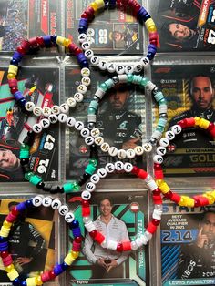 the olympic rings made out of beads are on display in front of other sports memorabilia