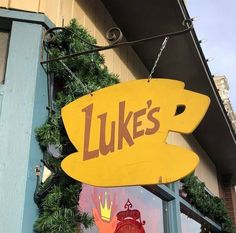 a yellow sign that says luke's on the side of a store front window