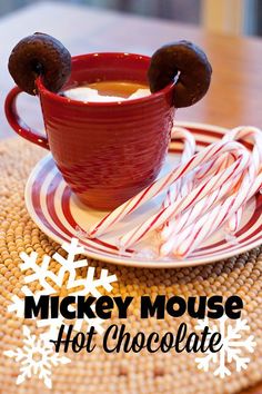 mickey mouse hot chocolate in a mug with marshmallows and candy canes