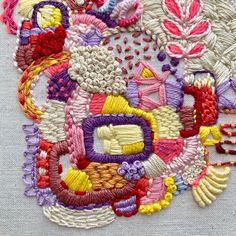 a close up of a piece of art made out of different types of stitchs