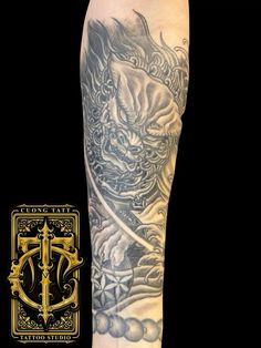 a man's leg with tattoos on it and an image of a dragon in the background