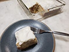 a piece of cake sitting on top of a blue plate next to a glass container