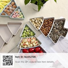 several trays filled with assorted fruits and vegetables on top of a white table