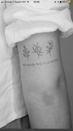 a woman's leg with flowers on it and the words, no rainflowers