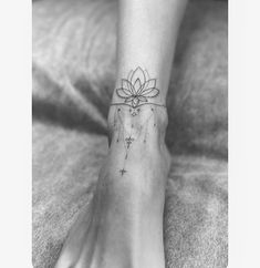 a woman's foot with a flower tattoo on the left side of her leg