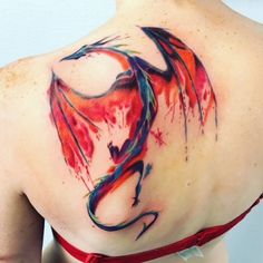 a woman with a dragon tattoo on her back