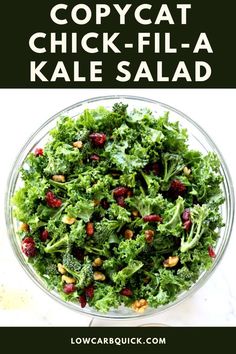 a bowl filled with kale salad and topped with cranberries