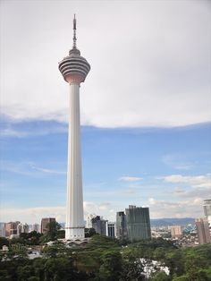 a tall white tower with a sky scraper in the middle of it's top