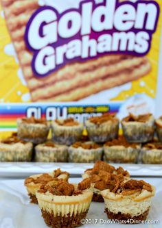 some cupcakes sitting on top of a white plate next to a box of golden graham's