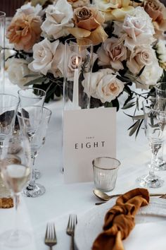 an elegant table setting with flowers and candles