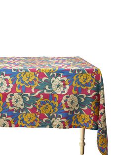 an image of a colorful table cloth on a white background with floral design in blue, yellow and pink colors