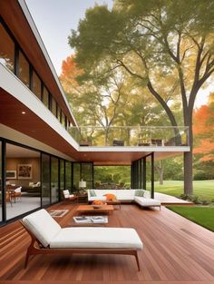 an outdoor living room with wood floors and white furniture on the outside decking area