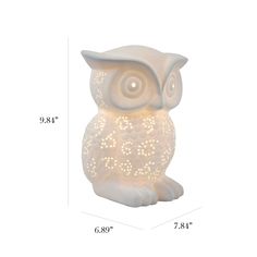 an owl light sitting on top of a white table next to a measuring ruler with the measurements