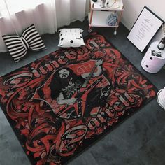 a living room area with a rug and various items on the floor, including a guitar