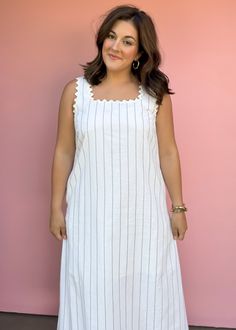 Get ready for summer with our Sea Worthy Linen Midi Dress! Effortlessly stylish with stripes and ric rac trim, this lightweight dress is perfect for vacations and beach days. Sun, sand, and style all in one piece! True to size Piper is wearing large Color: White with black pin stripes Stripe print square neck sleeveless midi dress featuring ric rac trim. Pocket at sides. Lined. Woven. Non-sheer. Lightweight. Fabric: 55%COTTON 35%LINEN 10%POLYESTER Fabric has no stretch Pull on design Summer White Dress With Vertical Stripes, Striped Lined Beach Dresses, Sleeveless Striped Beach Dress, Spring Beach Dresses With Vertical Stripes, Summer Dresses With Vertical Stripes For Vacation, Summer Dress With Striped Hem For Day Out, White Summer Dress With Vertical Stripes, Summer White Dresses With Vertical Stripes, Striped Linen Beach Dress