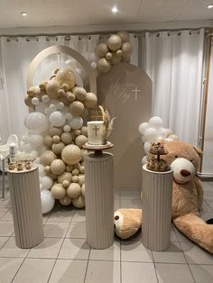 balloons and decorations are on display in a room decorated with white, gold and silver