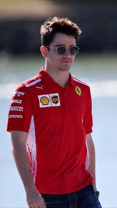 a man wearing sunglasses and a red shirt