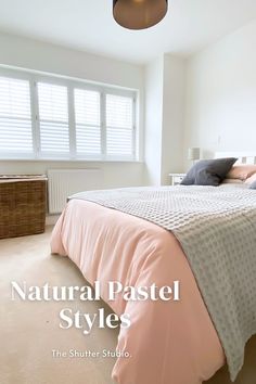 a bedroom with white walls and beige carpeted flooring, along with a pink bed cover