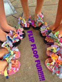 four people wearing flip flops with colorful bows on them