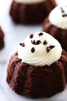 chocolate cupcakes with white frosting and chocolate chips