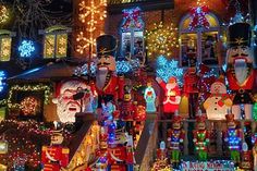 christmas lights and decorations on display in front of a house