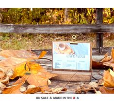 a wooden table topped with lots of leaves and a sign that says cafe mez