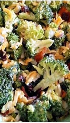 broccoli salad with cranberries and almonds in a white bowl on a table