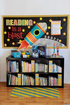 there is a book shelf with books on it and a rocket ship painted on the wall