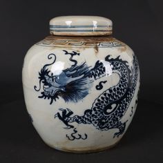 a blue and white vase with a dragon on it