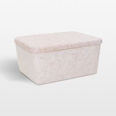 a white box sitting on top of a white floor next to a gray wall or floor