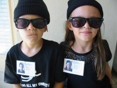 two young children wearing sunglasses and hats