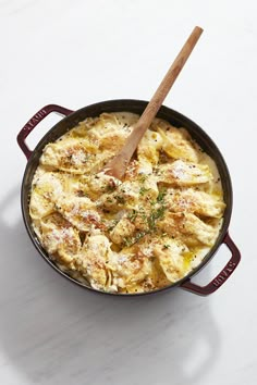 a skillet filled with food on top of a white table