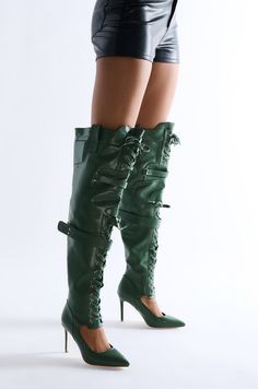 Everyone will be green with envy for the AZALEA WANG Shale Green Lace Up Boot. Crafted from a faux leather upper, these thigh-high beauties feature a pointed toe silhouette, a slim stiletto heel, tonal stitching, and a lace-up shaft with silver metallic hardware. Complete with decorative strap accents throughout, a tonal back zipper closure, and side pull tabs. Style with a bodysuit and statement earrings for a stylish ensemble.  (all measurements are approximate from size 7.5) - Faux Leather Upper - Pointed Toe - Stiletto Heel - Thigh-High Shaft - 3.75” Heel Height - 23.5” Shaft Height - 21” Shaft Opening Circumference - Imported  Product ID: 428067 Azalea Wang, Green With Envy, Green Lace, Stiletto Heel, Thigh Highs, Lace Up Boots, Stiletto Heels, Metallic Silver, Heel Height