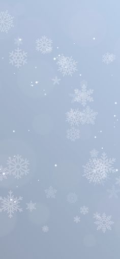 snow flakes are falling down on a blue background