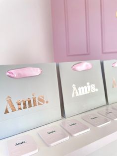 three shopping bags sitting on top of a counter next to each other with the word annis printed on them