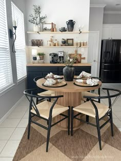 a kitchen table with chairs around it