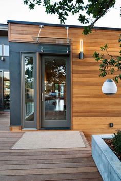 a modern house with wood siding and glass doors