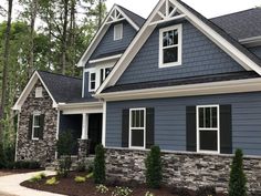 a blue house with black shutters and white trim