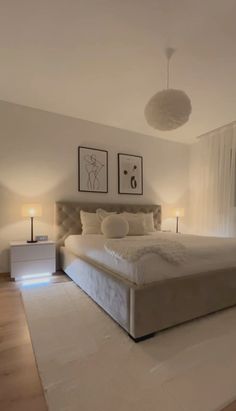 a large bed sitting in the middle of a bedroom next to two lamps on either side of it