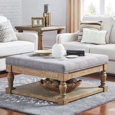 a living room scene with focus on the footstool and table in the background