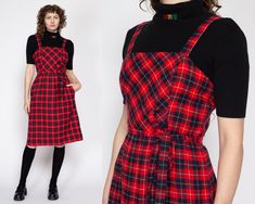 "Vintage 70s red & black plaid midi pinafore dress with a matching optional tie at the waist, and hip pockets. Shown modeled over a black top, not included with purchase. Measurements and Condition: Fits like: Labeled size 12, fits modern women's medium Fabric: Feels like wool - labeled dry clean only Brand: Route One Petite Miss, union made in USA Condition: Excellent Length: 41.5\" Chest: 37\" Waist: 28\" - cinches with tie Hips: 43\"  Shown on a 5'8\" model with measurements of 34\"-26\"-37\" Midi Pinafore Dress, Overall Jumper, Pinafore Dress, Vintage Belts, Red And Black Plaid, Dress Vintage, Black Plaid, Jumper Dress, Black Top