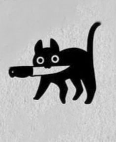 a black cat with a knife in its mouth on a white wall and the image is made out of paper