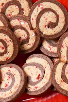 some very tasty looking cookies on a red plate with candy canes in the middle