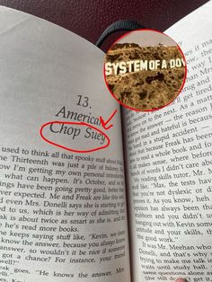 an open book with the title system of a dog circled by a red marker on it