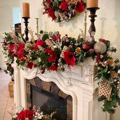 a fireplace decorated with christmas wreaths and candles