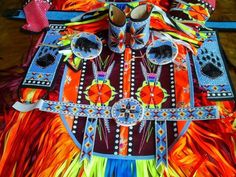 an elaborately designed costume with feathers and beads