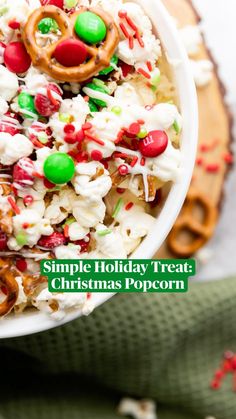 a white bowl filled with christmas popcorn and pretzels