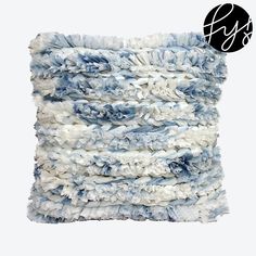 a blue and white throw pillow made out of yarn on top of each other with frayed edges