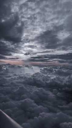 the view from an airplane looking down on clouds