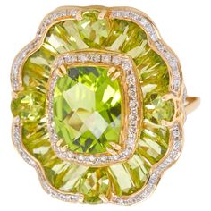 14 karat yellow gold peridot special cut flower contemporary cocktail ring A stunning showcase of vibrant elegance and timeless design, this peridot tapered baguette ring is crafted in 14 karat rose gold. Crafted in lustrous 14 karat gold, this ring features a central cushion-cut peridot, prong-set to command attention with its distinct green hue. Surrounding the central gemstone, a brilliant halo of diamonds adds a touch of sophistication and amplifies the overall radiance. The contrast between the green peridot and the dazzling diamonds creates a captivating visual allure. Extending the beauty beyond the central gem, the ring is adorned with a series of fancy-cut peridot gemstones. Each peridot is meticulously surrounded by pave-set diamonds, enhancing the intricate details of their uniq Tapered Baguette Ring, Baguette Ring, Peridot Gemstone, Green Peridot, Cut Flowers, Cocktail Ring, Cushion Cut, Intricate Details, Cocktail Rings